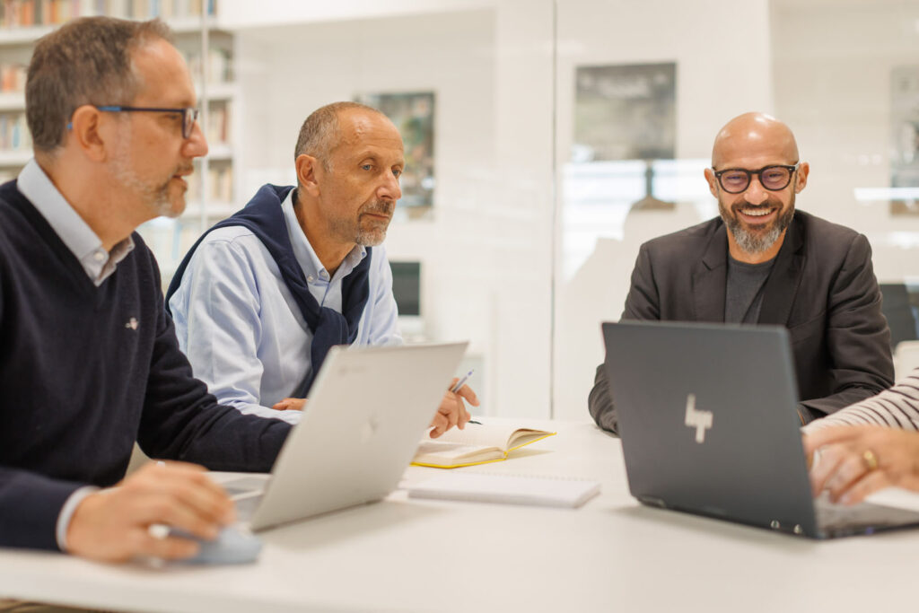 Three men collaborating in an office.