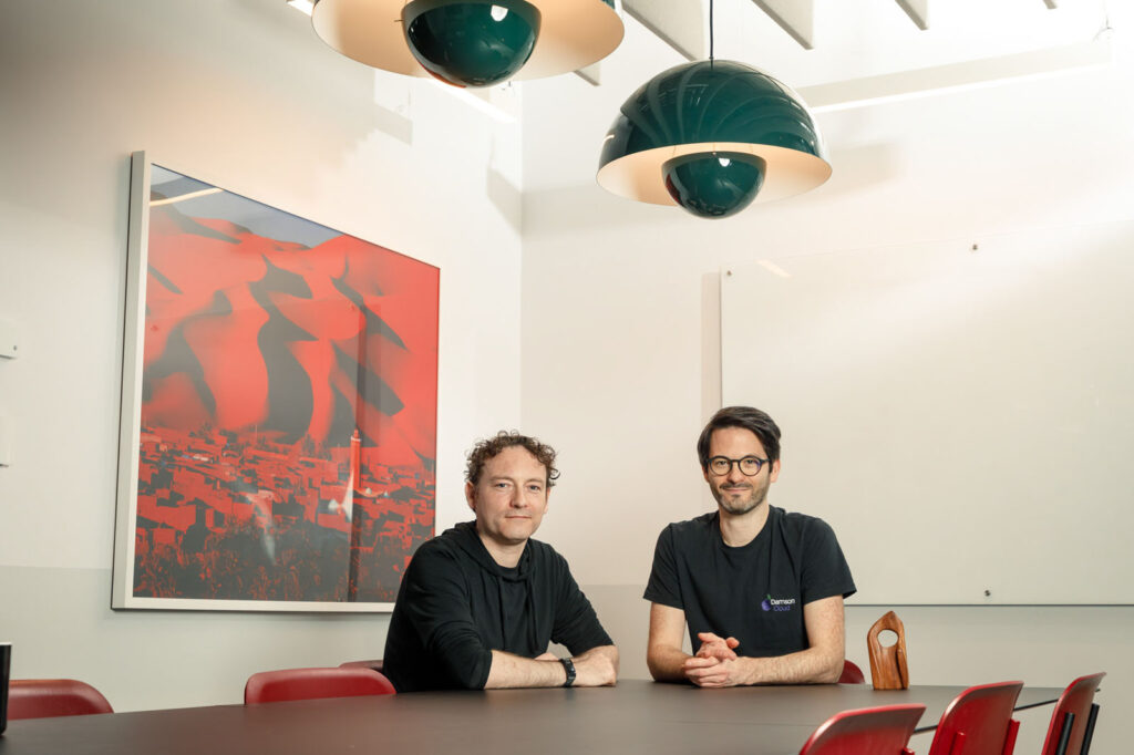 Two men in an office meeting room.