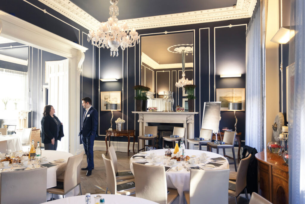 Two people talking in a luxurious event room.