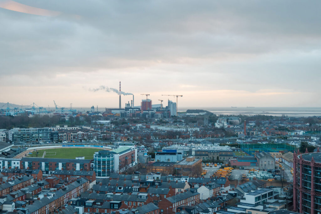 Urban landscape featuring industrial port, residential areas, and stadium.