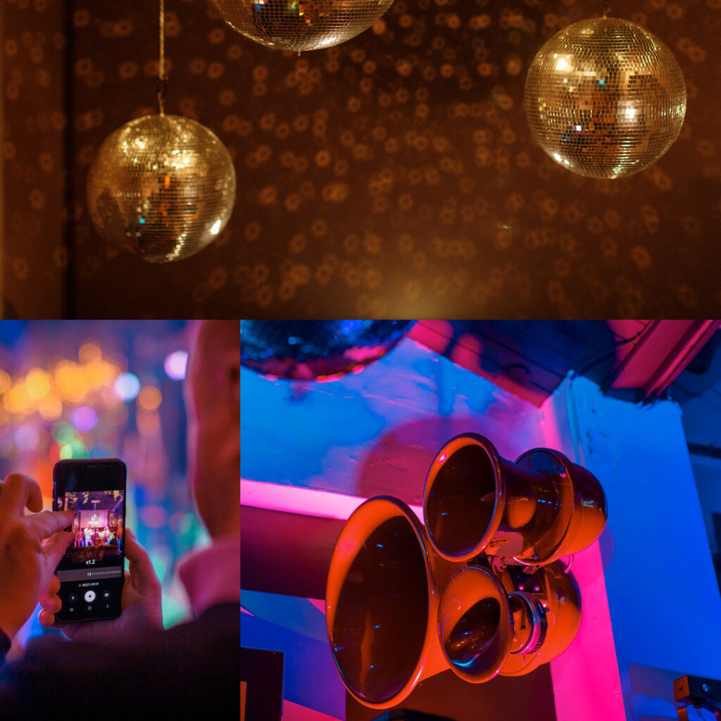 Vibrant party with disco balls, speakers, and smartphone recording.