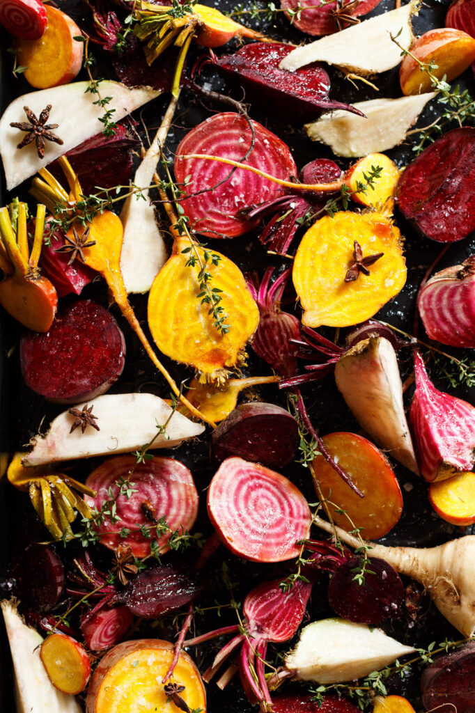 Vibrant roasted root vegetables, seasoned with herbs and star anise.