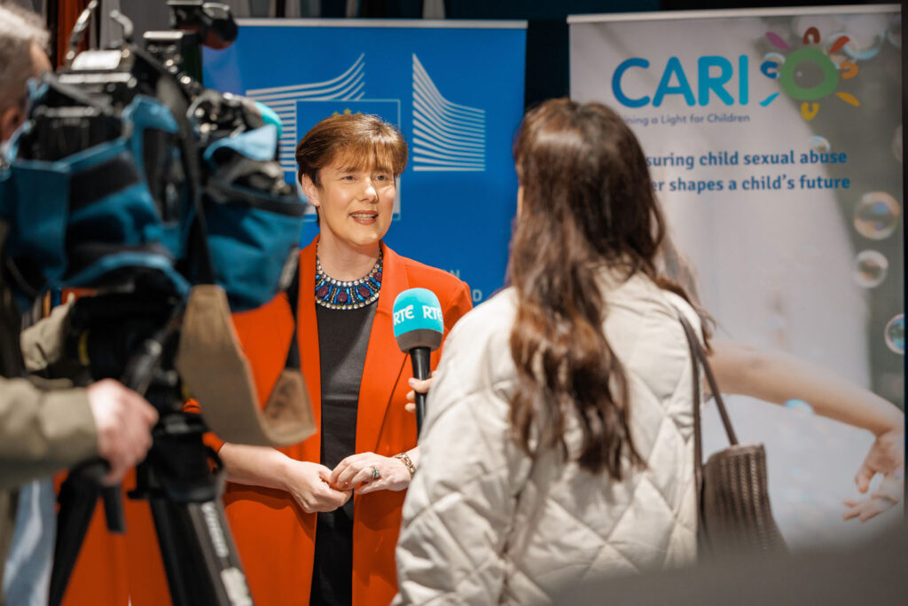 Woman interviewed by RTÉ at CARIS event.